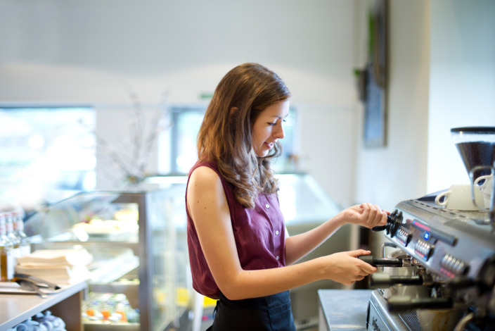 Junge Frau arbeitet in einem Cafe