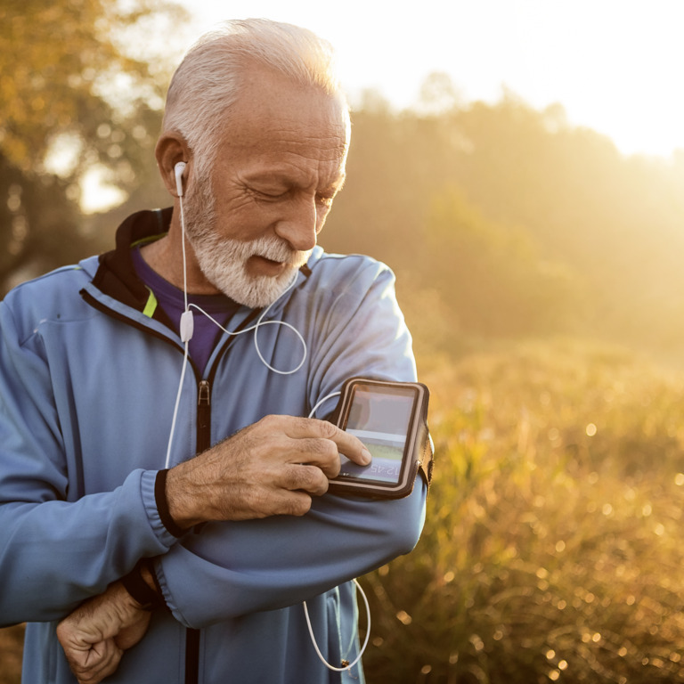 Älterer Herr nutzt Herz-Apps beim Cardio-Training