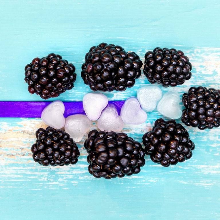 Eiswürfel in Herzchenform, Brombeeren und ein Eisstiel