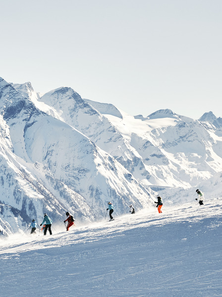 Gruppe von Skifahrern vor Bergkulisse
