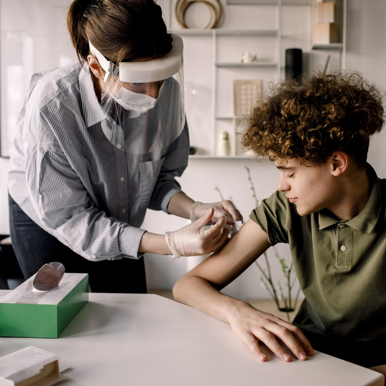 Teenager bekommt von seiner Ärztin eine HPV Impfung 